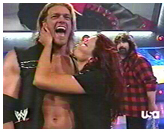 Edge and Lita on the same side as Foley